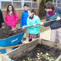 St Leo - Students add food scraps to the school compost